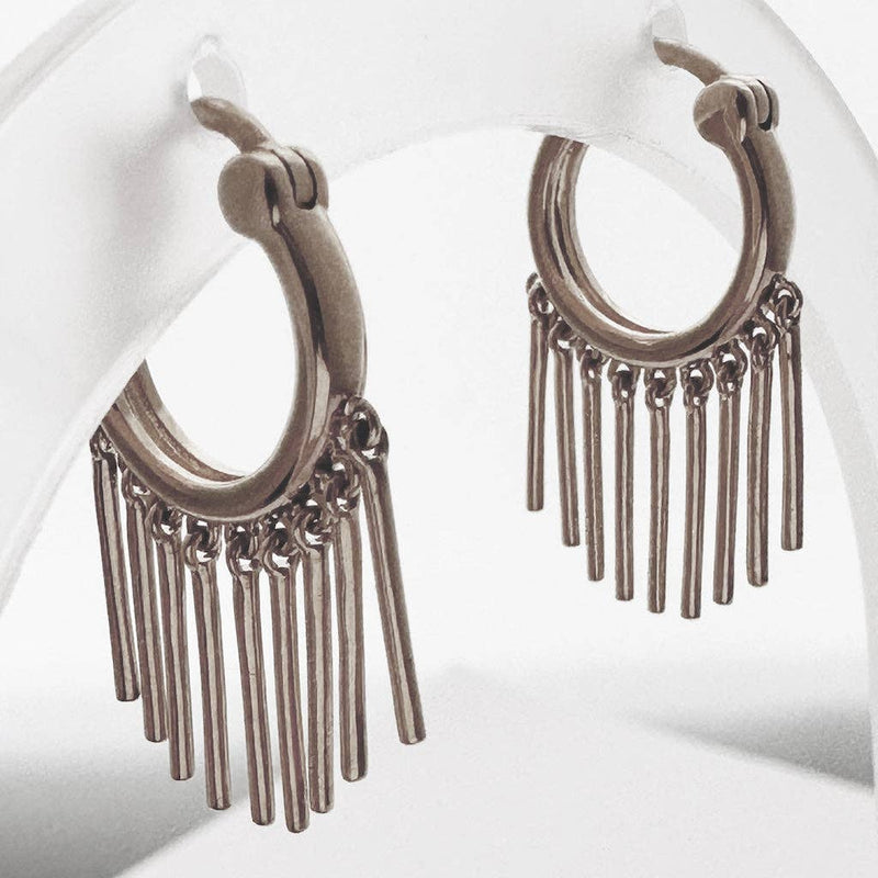 A pair of silver hoop earrings with nine bars hanging like a fringe along it.