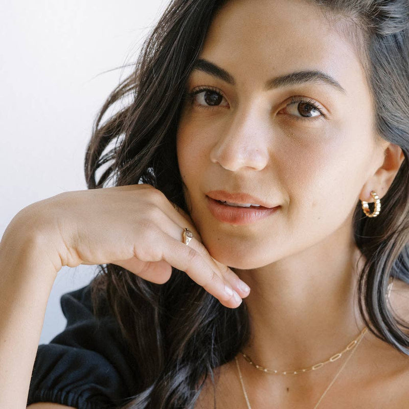 A person wearing the Flora Signet Ring in Gold.