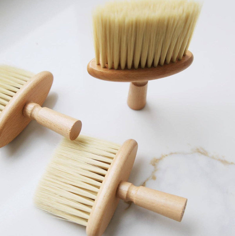 Three wide wooden cleaning brushes with long bristles.