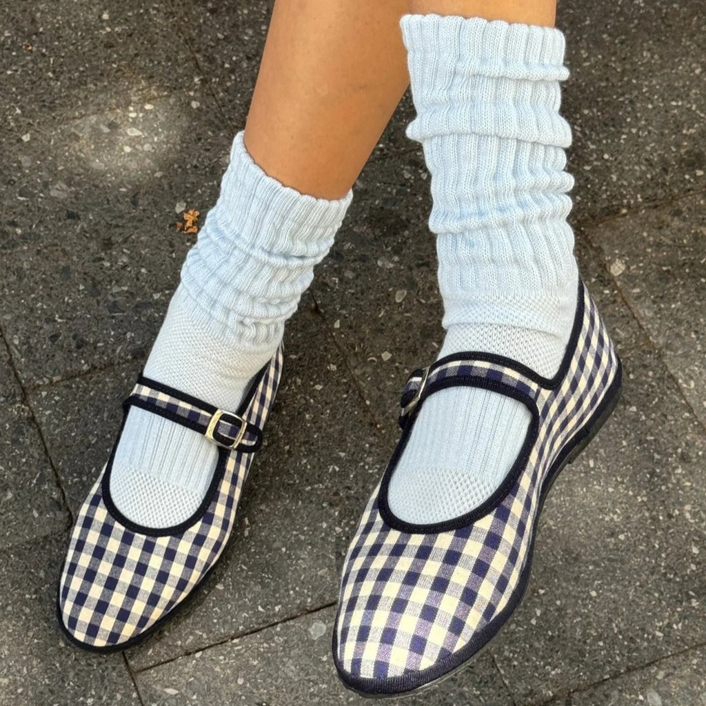 A person wearing the Ballet Socks in Baby Blue with navy blue gingham flats.