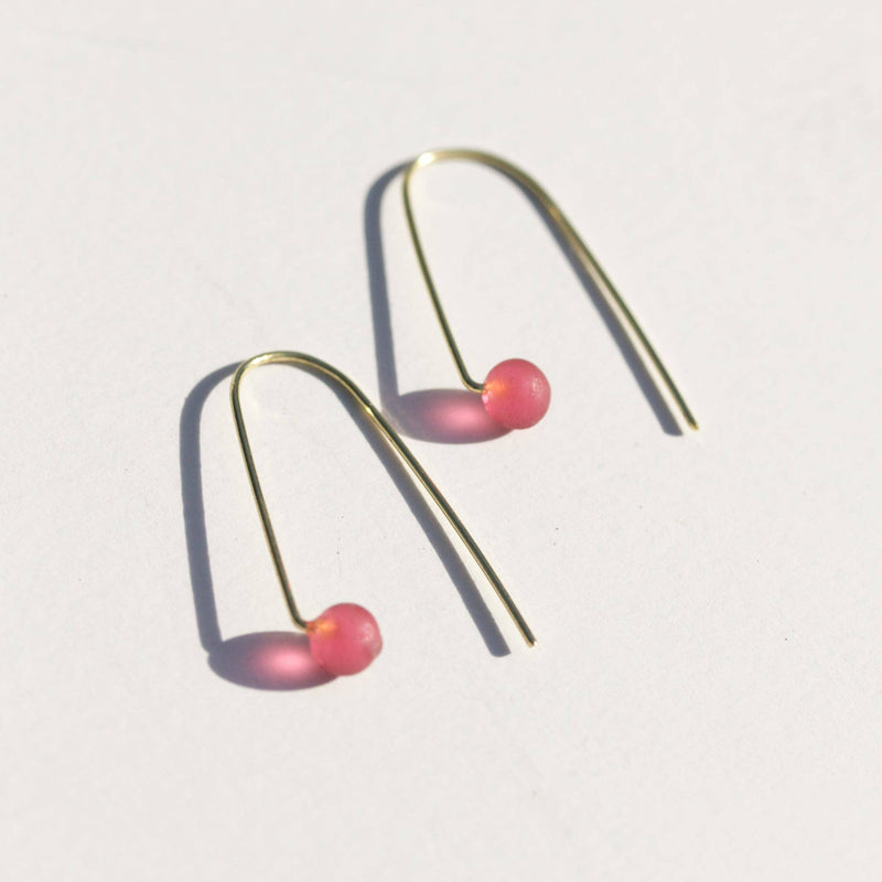 A close-up of the Sea Glass Threader Earrings in Rosé.