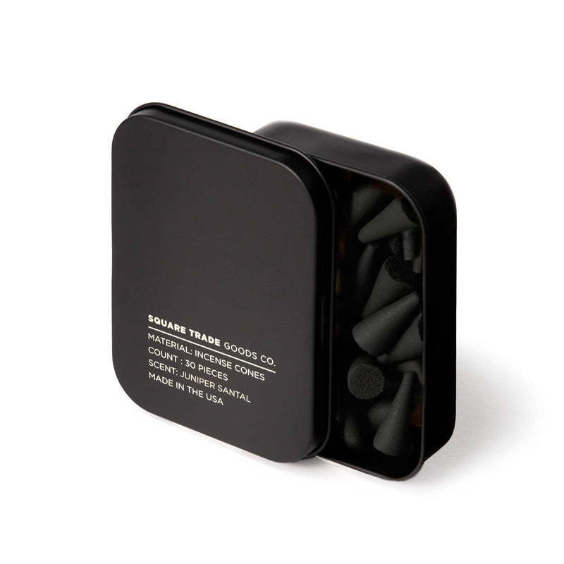 A matte black square tin filled with Juniper Santal Incense Cones.