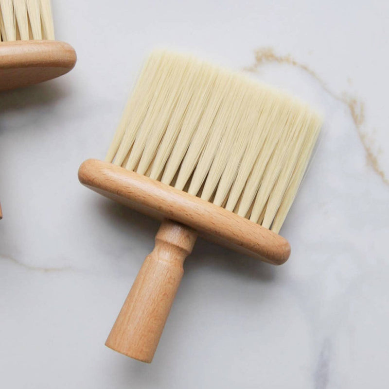 A wide wooden cleaning brush with long bristles.