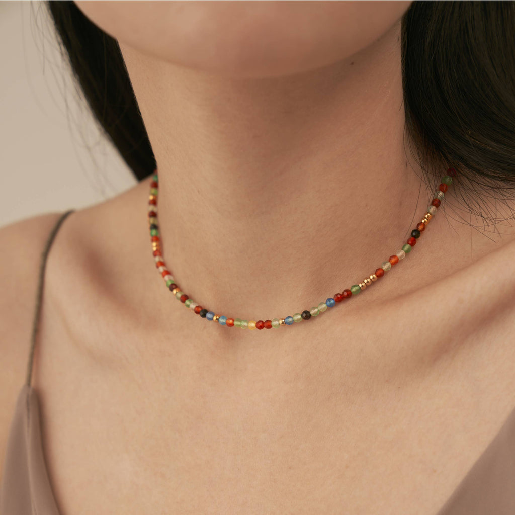 A person wearing the Rainbow Beaded Necklace.