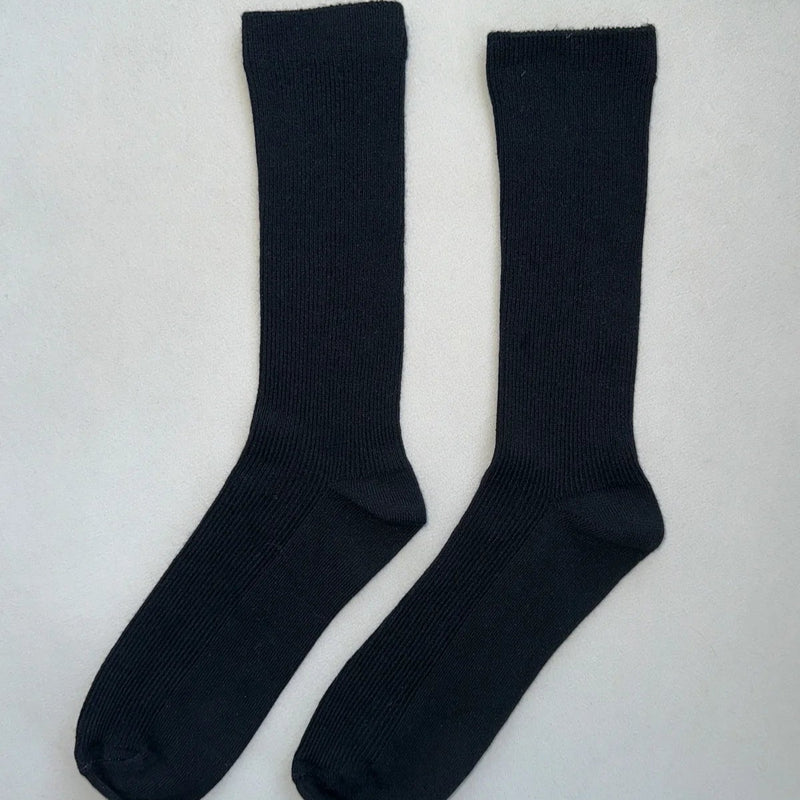 A pair of long calf length black socks.