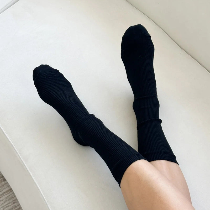 A person wearing the Trouser Socks in Black