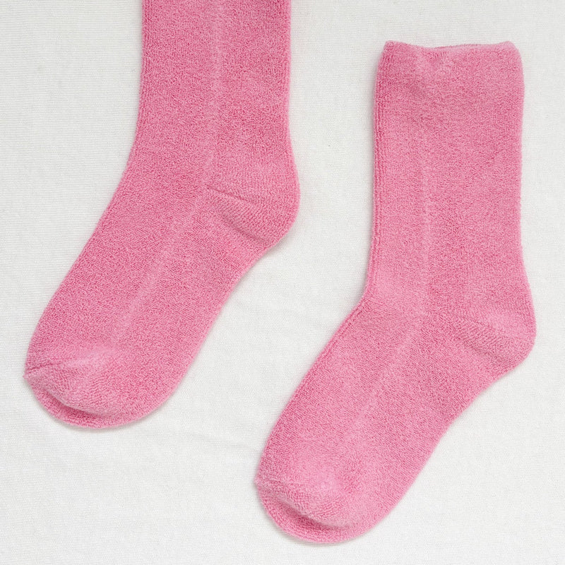 A fluffy pink pair of socks.