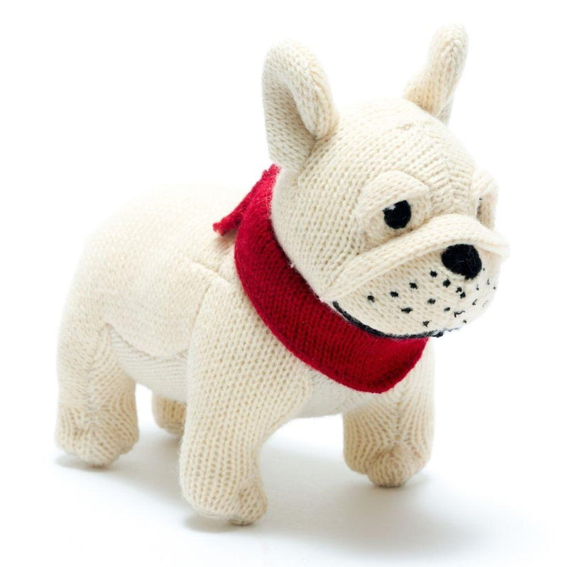 A cream knitted bulldog rattle wearing a red bandana.