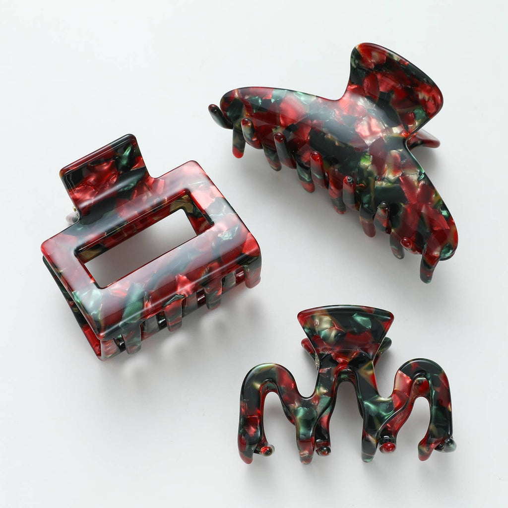 Three red, green, and gold patterned hair clips of various shapes.