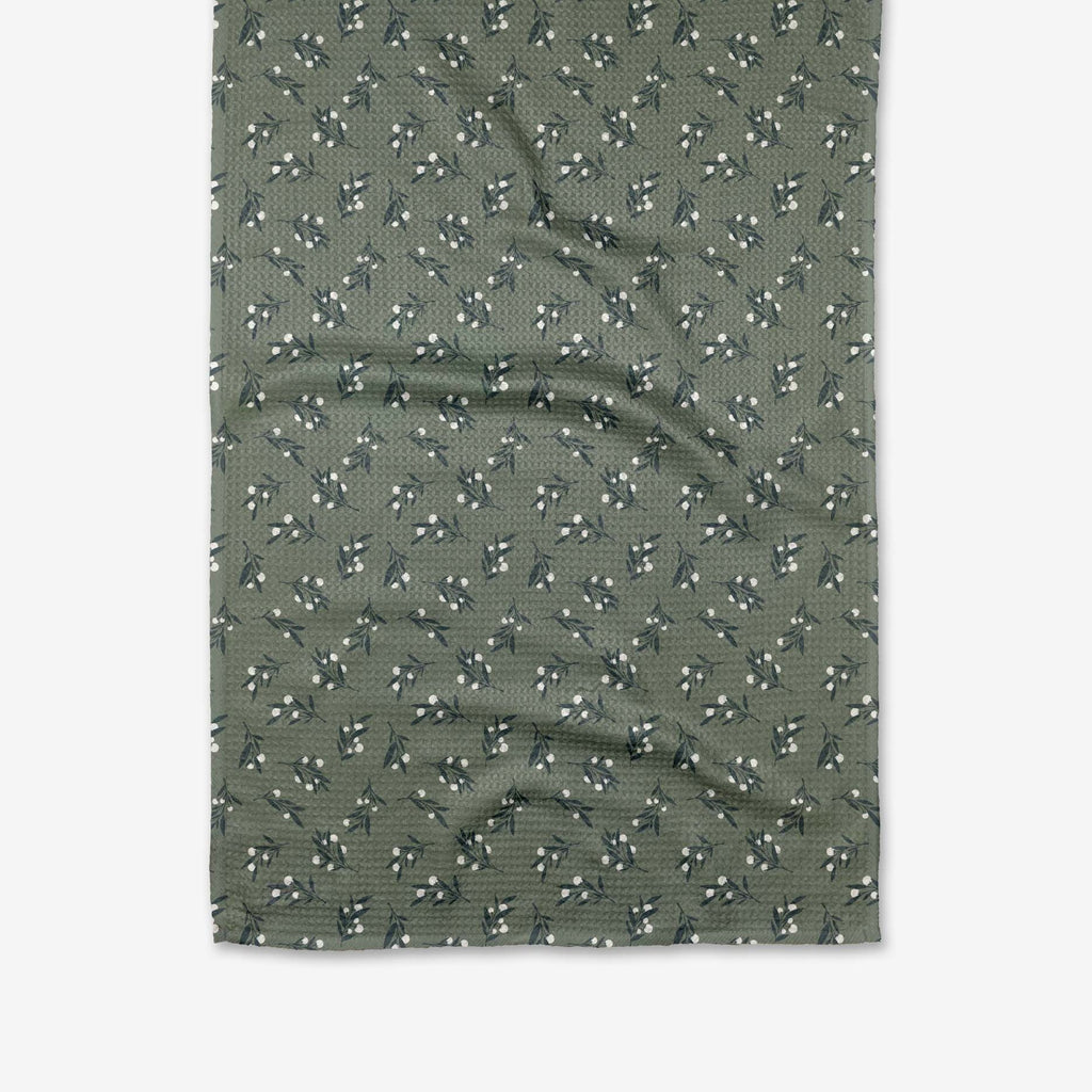 A sage green towel with tiny white berry sprigs pr