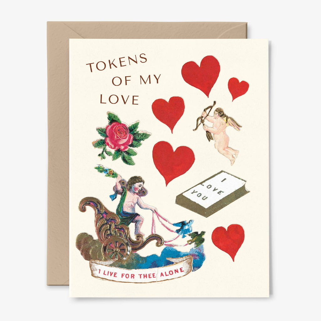 A cream card illustrated with vintage hearts, a cupid, a rose, and a cherub driving a chariot with the words "Tokens of My Love" and "I Live for Thee Alone".