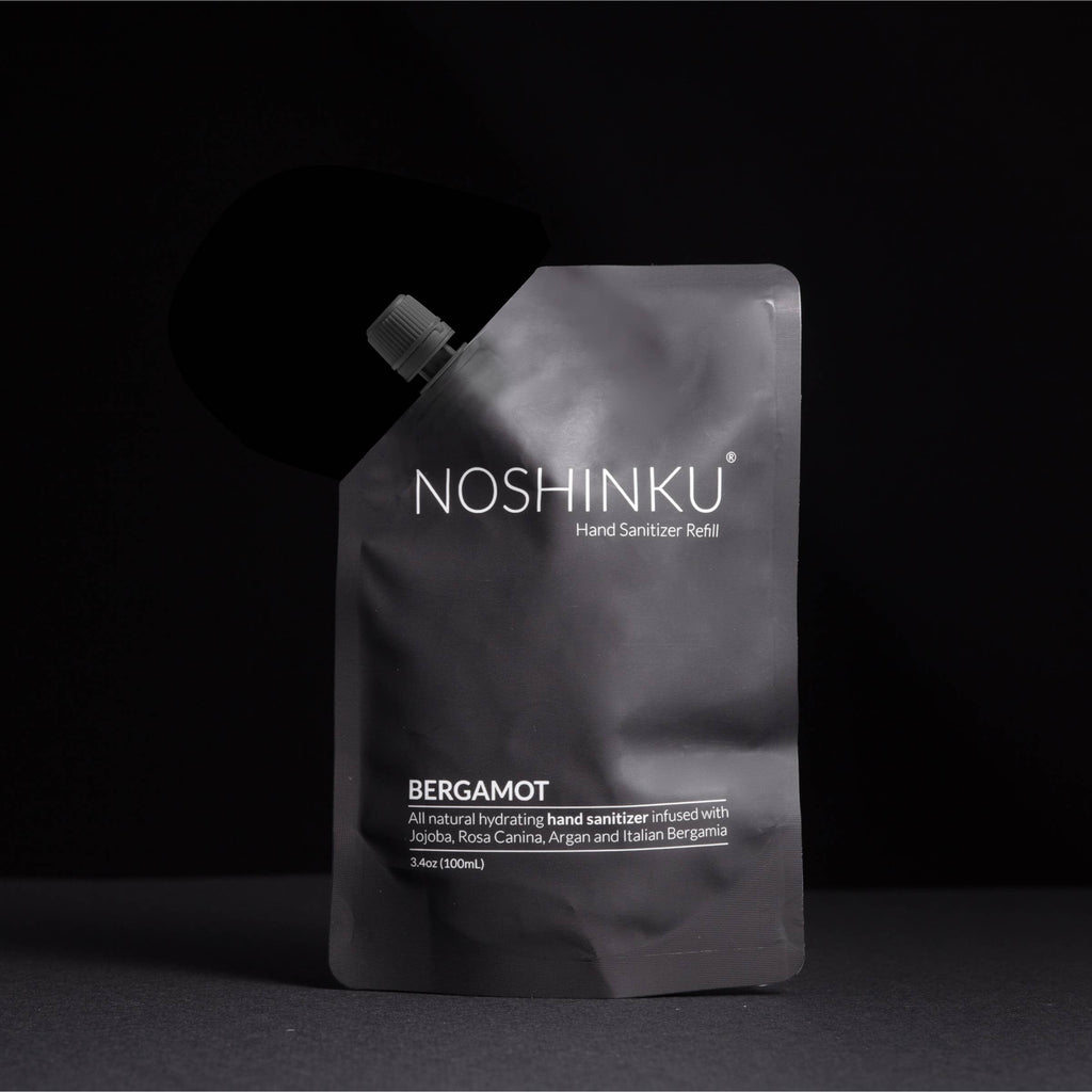 A matte black pouch labelled with Noshinku Hand Sanitizer Refill: Bergamot.