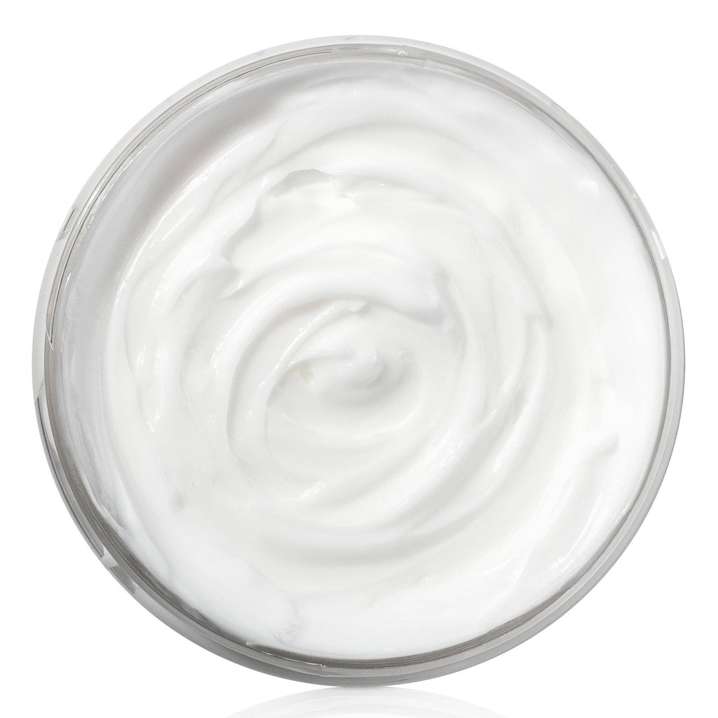 An open tub of white body butter.