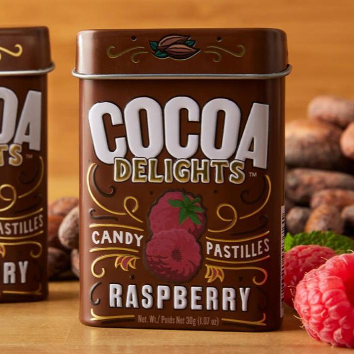 A brown tin of Raspberry Cocoa Delights candies.