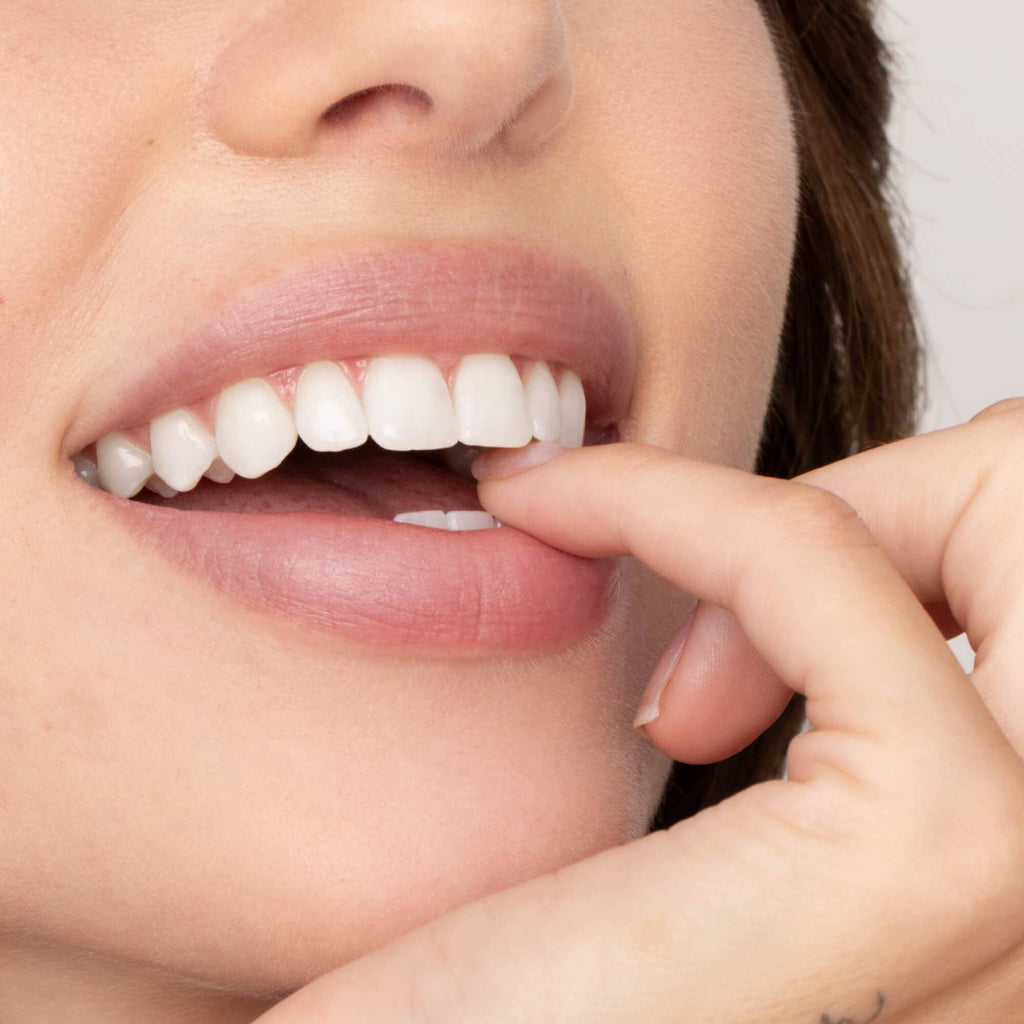 A close-up person with light skin wearing the Beverly Lip Tint.