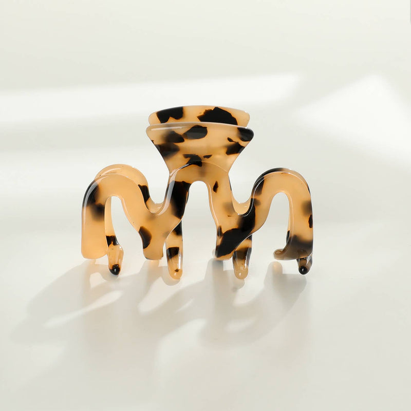 An Esme claw clip with a latte and black colored tortoise pattern.