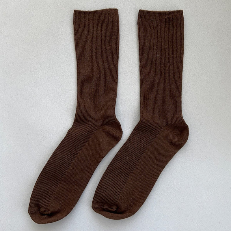 A pair of long brown thin weave socks.