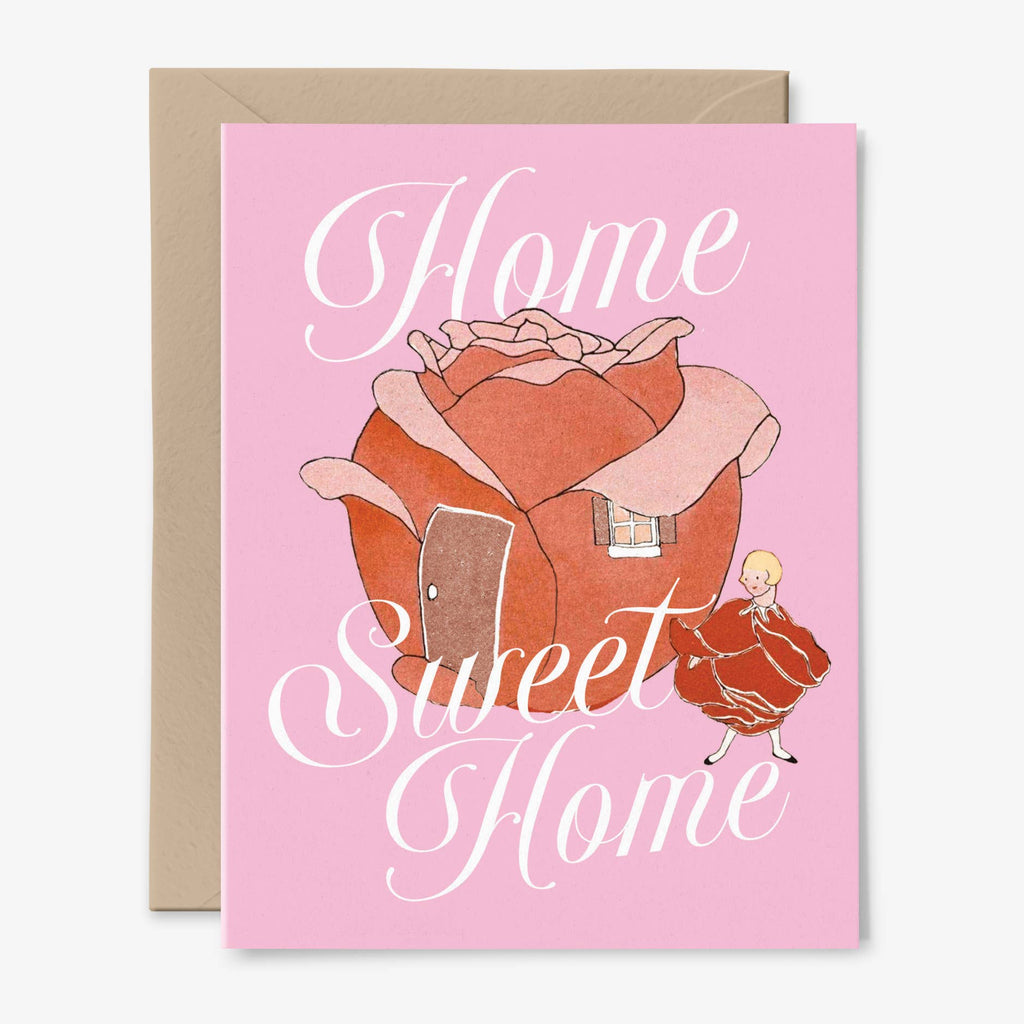 A pink card illustrated with a rosebud house next to a girl wearing a red flower petal dress and a kraft envelope.