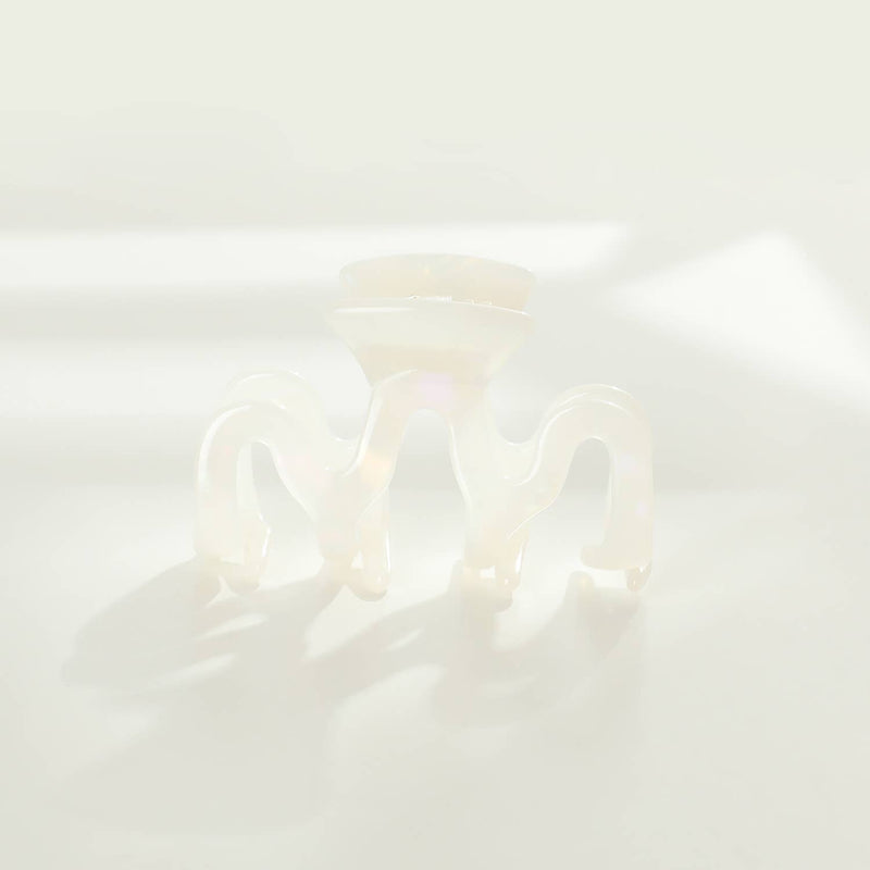 An Esme claw clip with a pale pastel pearlescent finish.