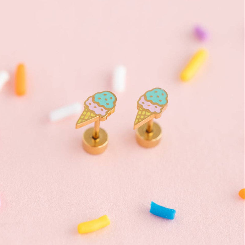 The Ice Cream Stud earrings on a pale pink background surrounded by rainbow sprinkles.