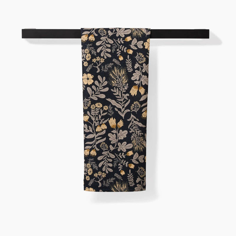 A Woodland Wildflowers Tea Towel hanging from a towel rack.