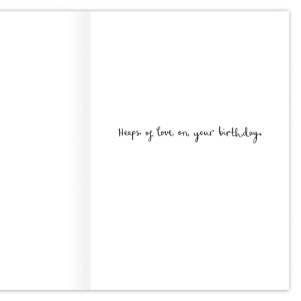 The inside of the card featuring the words "heaps of love on your birthday" written in cursive.