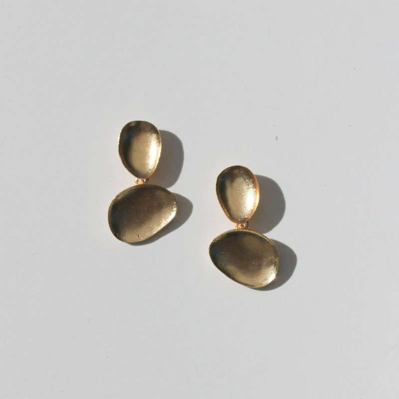 Two gold brass stud earrings with a natural round bowl shape attached to a smaller round bowl.