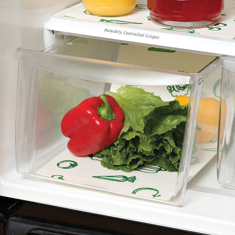 A fridge bin lined with the liner and filled with lettuce and peppers.