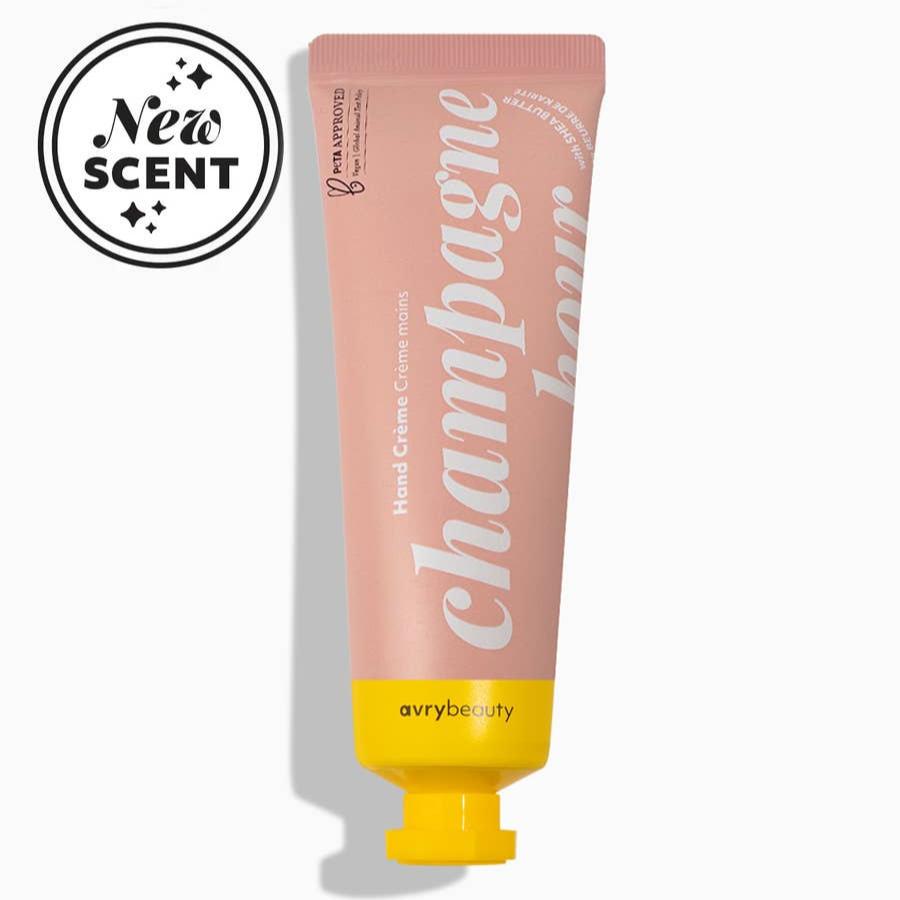 A pale pink tube of Champagne Hour Shea Butter Lotion with a yellow cap.