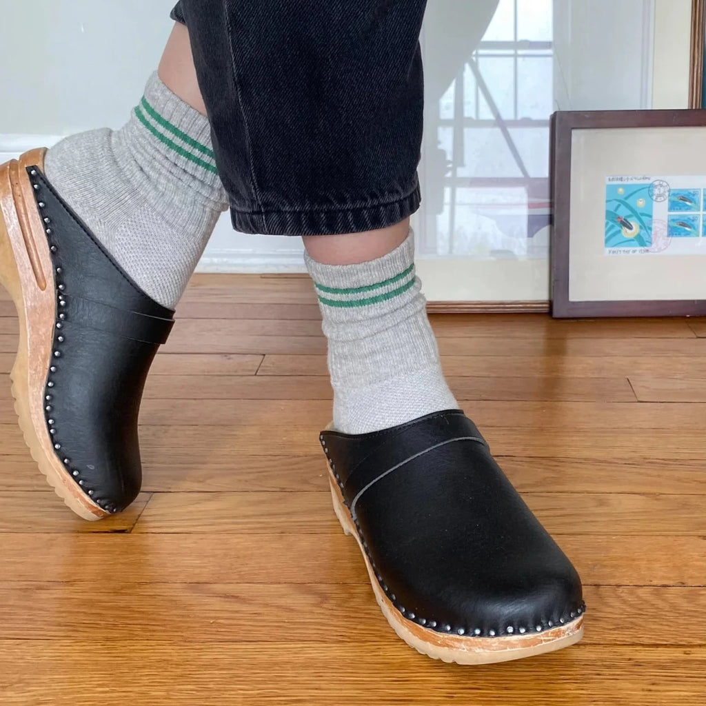 A person wearing the Light Grey Boyfriend Socks with black clogs.