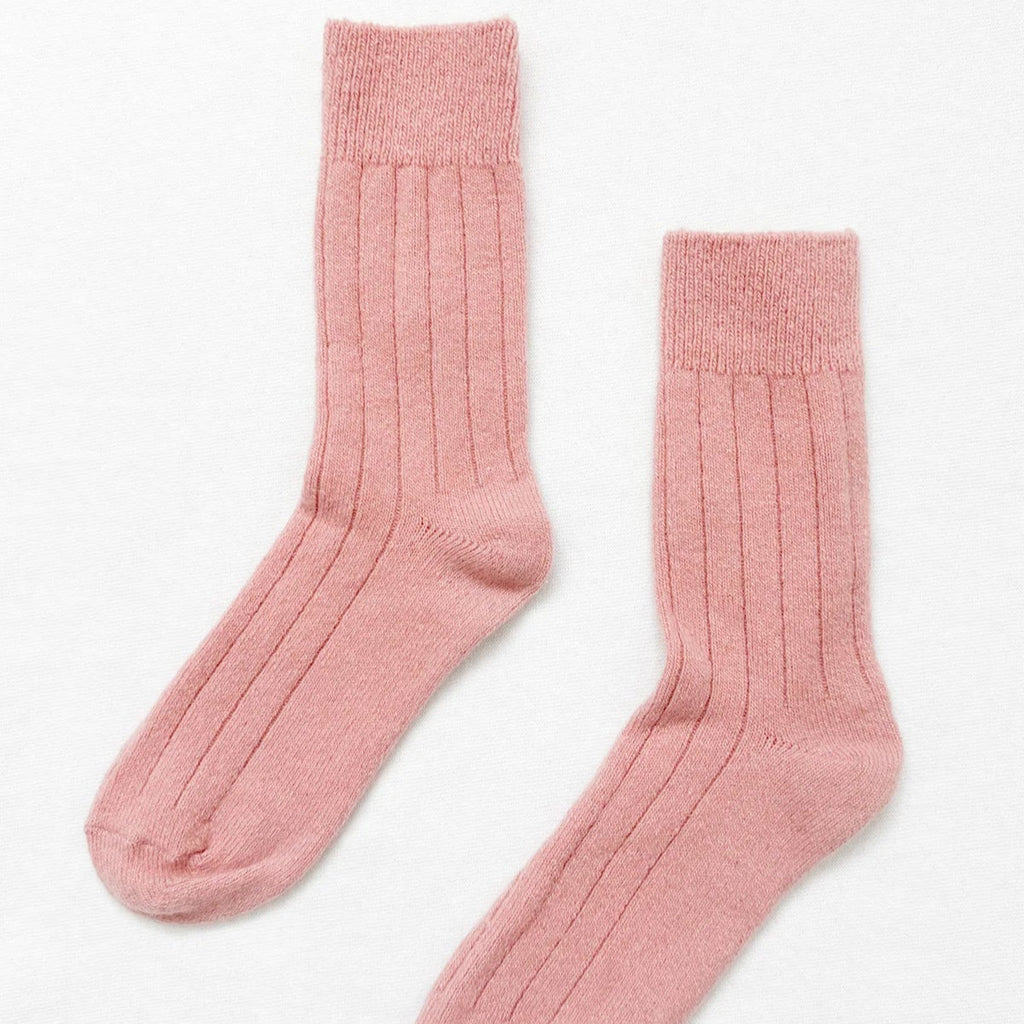 Two pale pink long ribbed mid calf length cashmere blend socks.