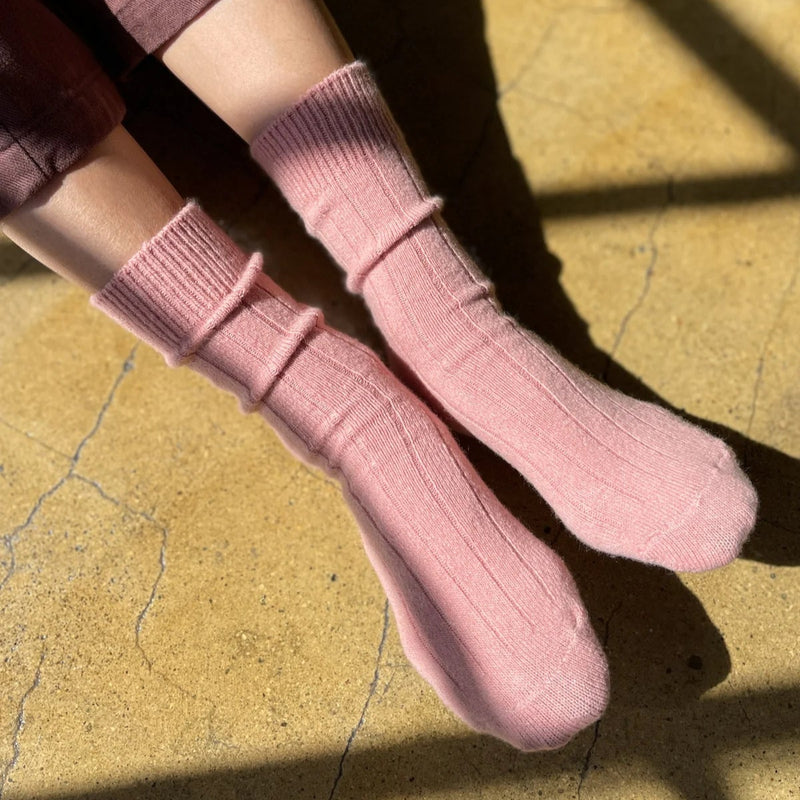 A person wearing the Cashmere Classic Socks in Rose Petal.