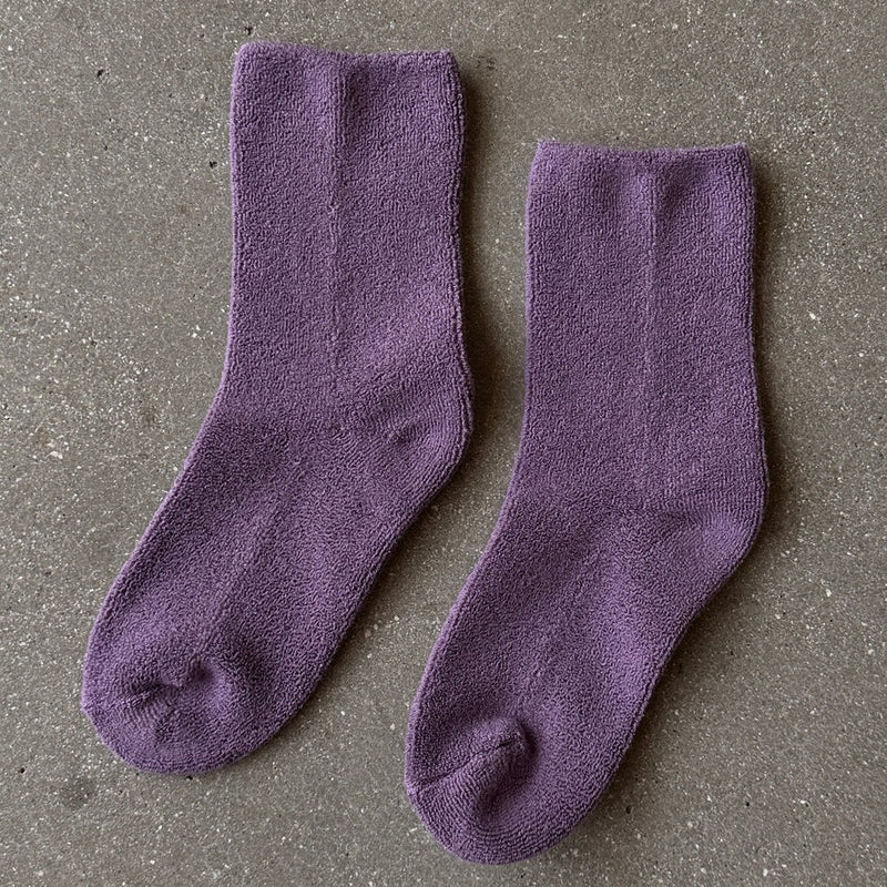 Two fluffy plum purple socks.