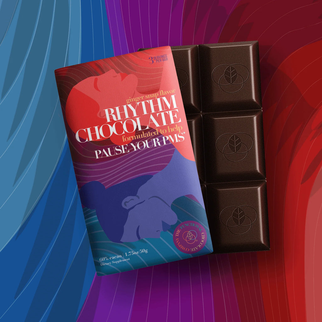 A bar of Rhythm Chocolate next to its red, purple and blue packaging.