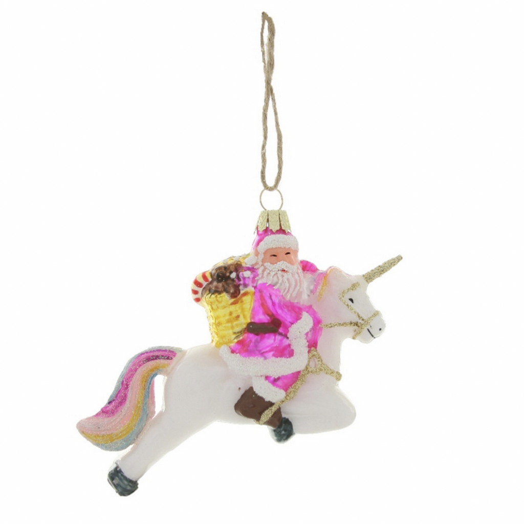 A Santa in pink riding a pastel rainbow unicorn ornament with a cord for hanging,