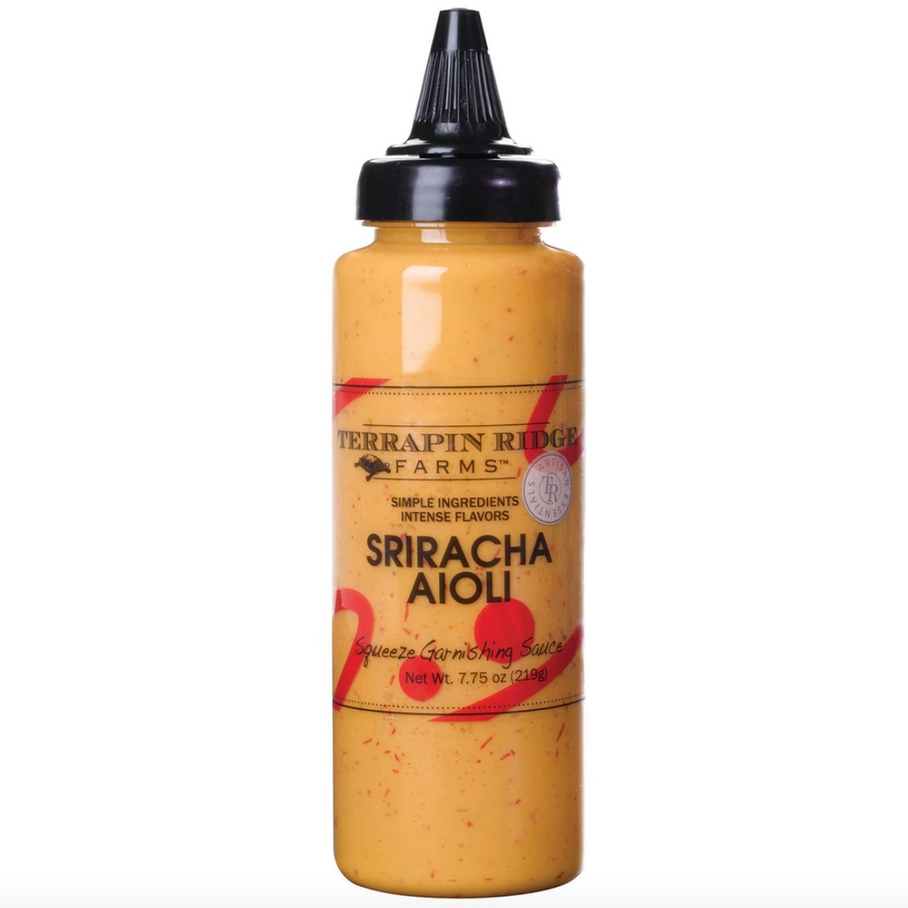 A clear plastic bottle of Sriracha Aioli sauce.