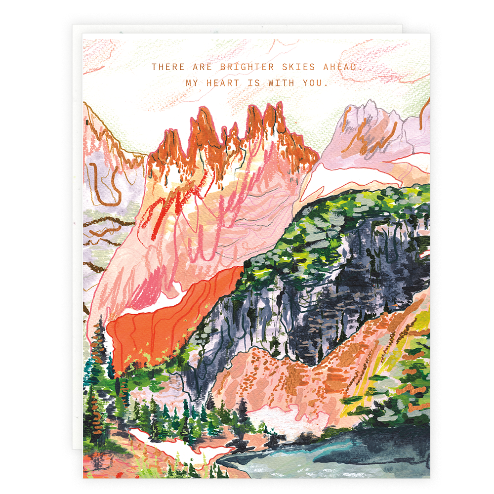 A water color and pastel card of a mountain scene with the words "There are brighter Skies Ahead. My Heart is with You" in gold foil.