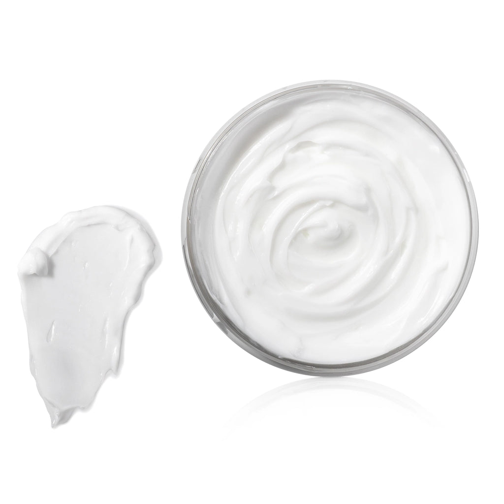 An open tub of white body butter next to a swatch.