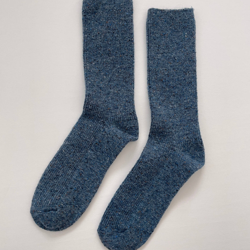 A pair of calf length speckled gray-blue socks.