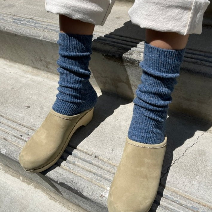 A person wearing the Snow Socks in Denim with tan slip-on shoes.