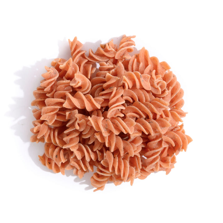 A pile reddish spiral-shaped pasta.